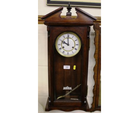 A reproduction mahogany two hole wall clock 