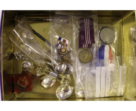 A tin containing various silver coffee spoons, mustard spoons, a bar brooch, silver handled button hook etc. 