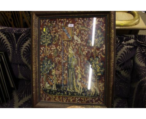 A large wool work tapestry depicting figures in a woodland