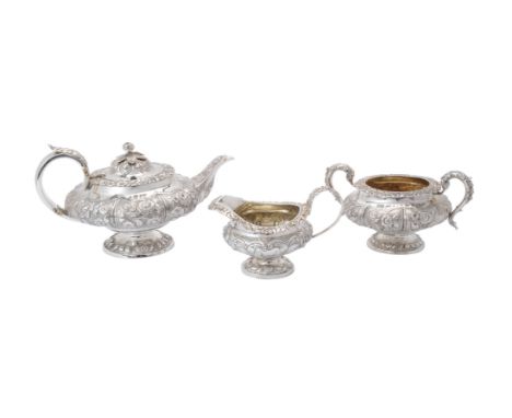 A matched George IV silver lobed circular pedestal three piece tea service, the tea pot and cream jug by William Hunter, Lond