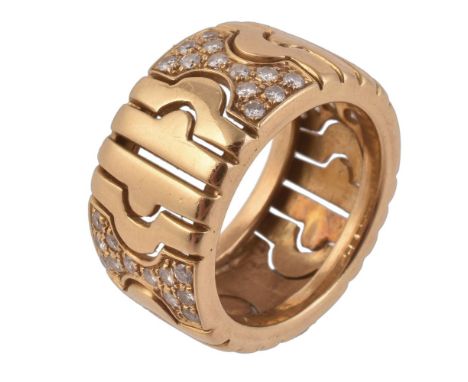 A diamond and gold coloured ring, the pierced band set with brilliant cut diamonds, approximately 0.37 carats total, finger s