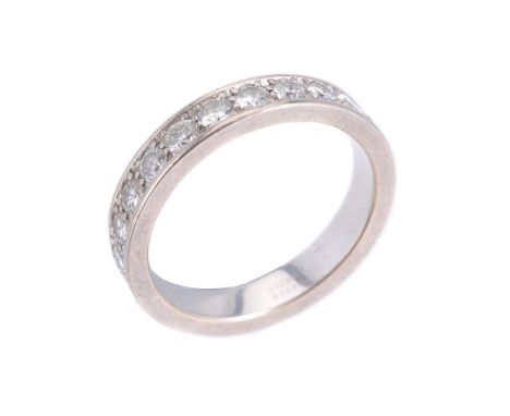 A diamond eternity ring by Chopard, set all round with twenty three brilliant cut diamonds, grain set, polished gallery and c