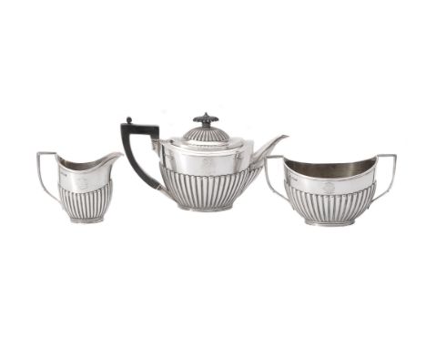 A late Victorian silver oval tea service by The Goldsmiths &amp; Silversmiths Co. Ltd, Sheffield 1891, the tea pot with an eb