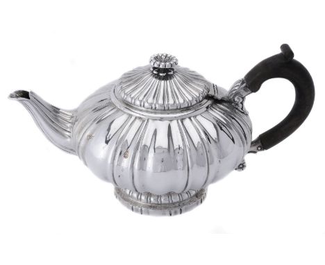 A George IV silver shaped circular tea pot by Robert Hennell II, London 1821, with a flower head button finial to the lobed d