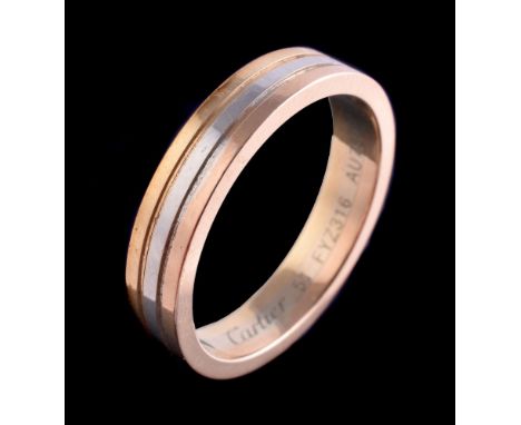 An 18 carat gold Trinity ring by Cartier, the three colour gold band with reeded detail, signed Cartier, stamped AU750, Numbe