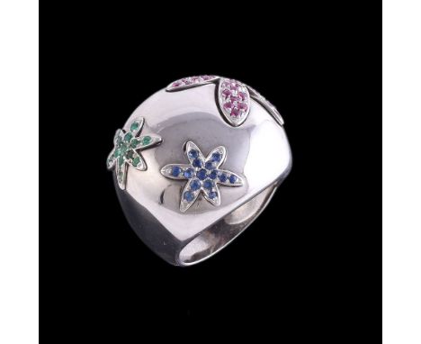 A ruby, sapphire and emerald flower head dress ring, the cushion shaped polished panel with three graduated flower head inser