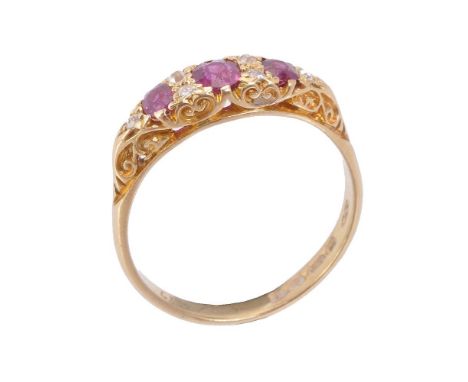 An 18 carat gold ruby and diamond ring, the three oval cut rubies with old cut diamonds in between, stamped 18 with Chester h