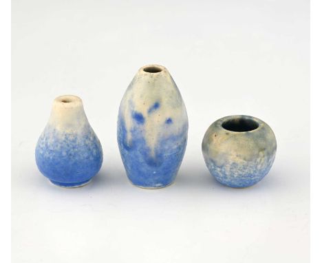 Ruskin Pottery, three miniature Crystalline vases, greenish cream over pale blue, including barrel, baluster and ovoid forms,