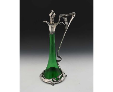 WMF (attributed), a Jugendstil silver plate mounted glass claret jug, the green trumpet form body encased with open sinuous w