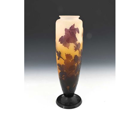 Emile Galle, a triple cased cameo glass trumpet flower vase, circa 1890, footed shouldered form, aubergine over amber over co