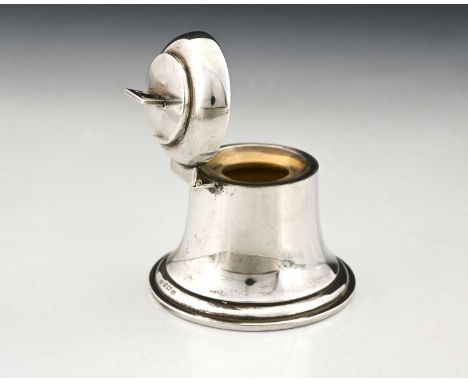 A George V silver novelty inkwell, modelled in the form of a bell, the hinged cover opening to reveal a gilt interior, and fi