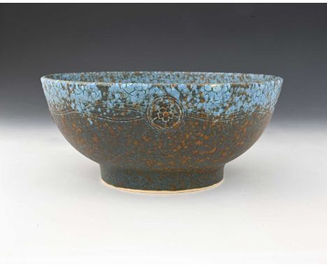 Ruskin Pottery, a relief moulded Crystalline bowl, circa 1932, footed form, applied with rosettes united by incised tendrils,