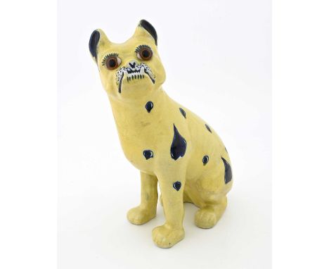 A faience figure of a pug dog, in the Mosanic/Galle style, modelled sitting upright, yellow ground with blue painted motifs, 