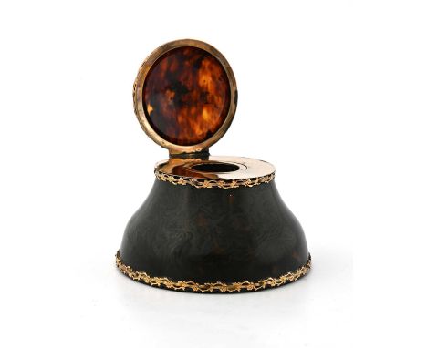 An Edwardian tortoiseshell inkwell, with gold-coloured metal mounts, the exterior applied with a pierced cast rim of floral t