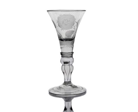 A Jacobite engraved light baluster wine glass, circa 1745, the flared trumpet bowl engraved with open rose and sunflower, on 