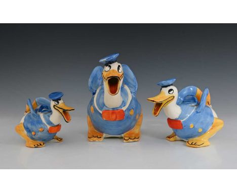 Walt Disney for Wadeheath, a novelty Donald Duck graduated trio of teapots, each modelled in sailors costume, beak open, the 