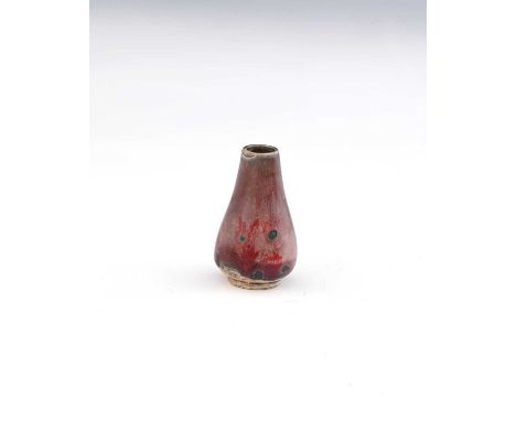 Ruskin Pottery, a miniature High Fired vase, circa 1920, conical baluster form, lavender and sang de boeuf flambe with green 