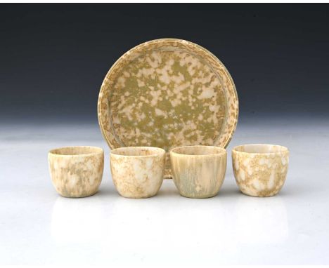 Ruskin Pottery, a Crystalline egg cruet, circa 1927, including four egg cups and a stand, in marbled cream over taupe, impres