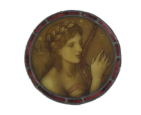 A Pre Raphaelite stained glass panel, circa 1890, painted with an allegorical figure of music playing the harp, within a circ