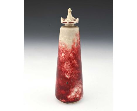 Ruskin Pottery, a High Fired scent bottle, 1927, conical form with crenelated screw top, sang de boeuf flambe over dove grey 