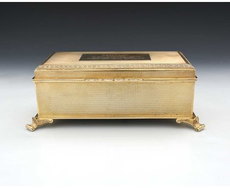 An Elizabeth II silver gilt jewellery casket, the exterior decorated with engine turning, the hinged cover with cast floral t