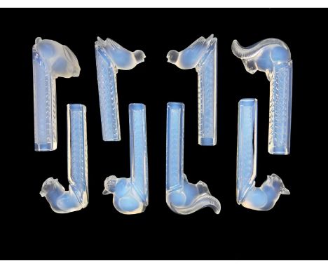 Etling, a set of eight Art Deco opalescent glass knife rests, circa 1925, each modelled with a forest animal, on a square sec