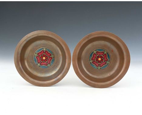 A pair of Arts and Crafts copper ane enamel dishes, circular for with everted rims, set with central roundels of champleve Tu