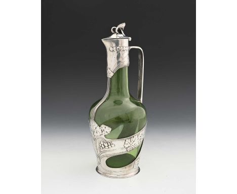 Orivit, a Jugendstil pewter mounted green glass claret jug, shouldered form encased with straps of relief cast fruiting grape