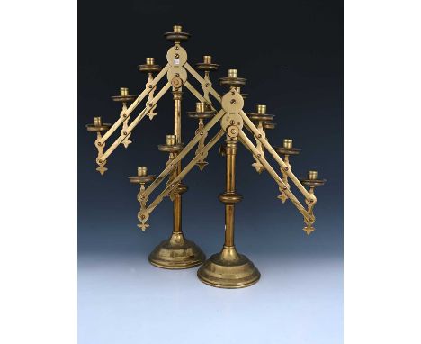 A pair of Gothic Revival brass adjustable candelabra, Maurice Vanpoulle, Westminster circa 1900, each of column form with mec