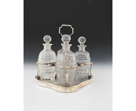 Paul Storr, a George III silver four-bottle decanter set, comprising a silver-mounted stand, the quatrefoil base ensuite with