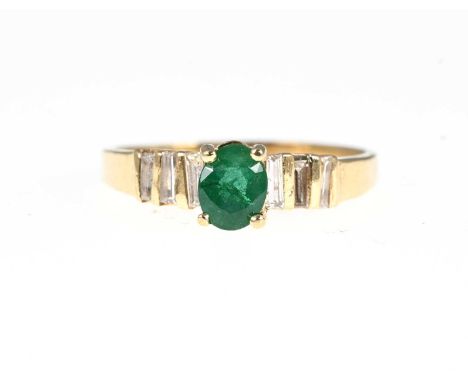 A 14ct gold emerald single-stone dress ring, with tapered baguette-cut diamond line shoulders, estimated total diamond weight