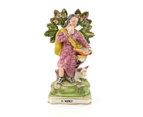 An Obadiah Sherratt Staffordshire figure of St Luke, circa 1820, modelled standing by a recumbent cow and boccage tree, readi