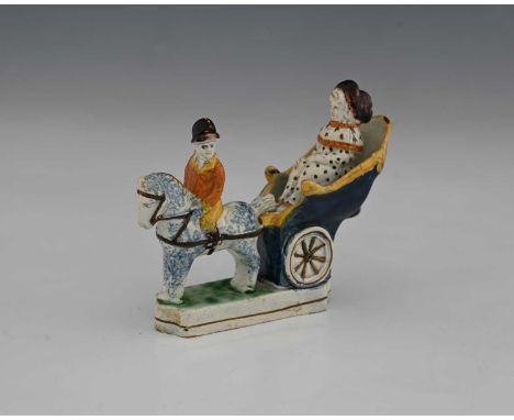 A small Staffordshire Prattware figure of a horse and carriage, circa 1820, sponge decorated, modelled with figures, 12cm lon