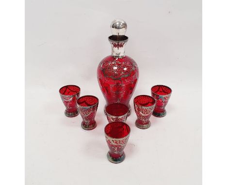 Ruby tinted silvered spirit decanter and stopper, 22cm high&nbsp;and six shot glasses, early 20th century, each decorated in 