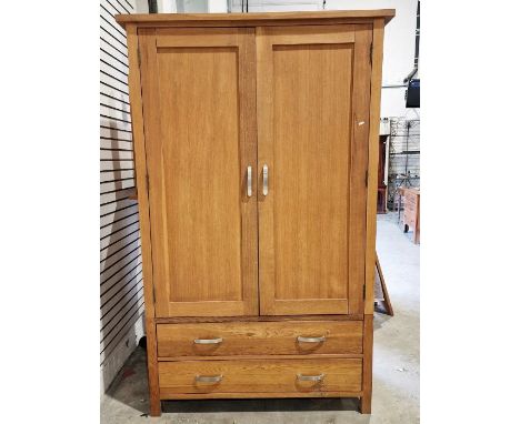 Modern oak two section wardrobe, the cupboard over two long drawers on square feet, H. 200cm x W. 125cm x D. 60cm and a match