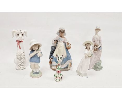 Two Lladro figures of girls,&nbsp; comprising a girl carrying a basket with kittens at her feet, enriched in matt glazes, ano