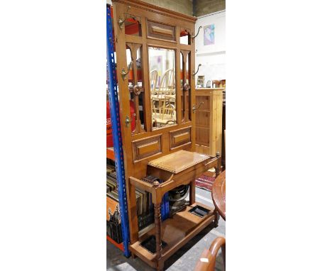 20th century oak hallstand with central bevelled mirror flanked by eight hooksCondition ReportThe height is 204cm, the width 