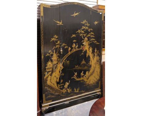 Early to mid 20th century Chinese style black lacquered wardrobe, the shaped front decorated with figures walking across brid