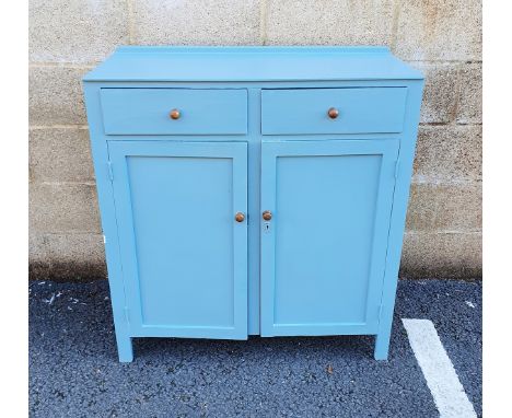 20th century blue painted wooden kitchen cupboard with two short drawers above two panelled cupboard doors enclosing a shelf,