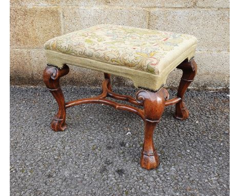 Carved walnut footstool&nbsp;in the early Georgian-style with rectangular tapestry top decorated with birds, on scroll cabrio