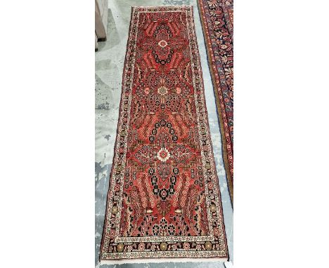 North West Persian Malayer red ground runner with one row of three floral medallions enclosed by floral pattern to single tra