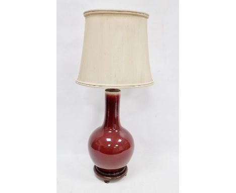 Chinese flambe bottle-shaped vase, probably 19th century,&nbsp;mounted as a lamp, glazed in dark red, mounted on wooden stand