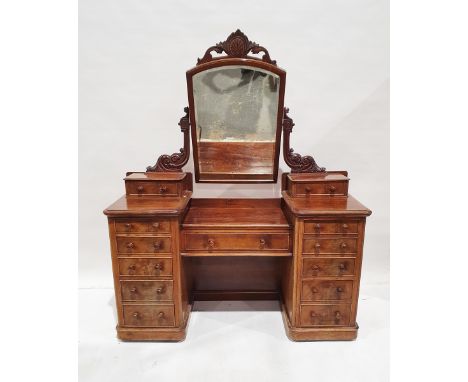 Victorian mahogany dressing table&nbsp;centred by a rectangular bevelled edged mirror, within carved foliate frame, flanked b