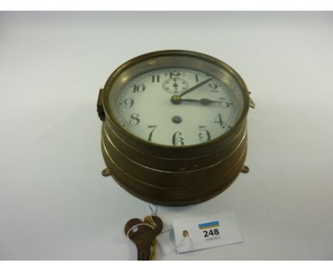 German U Boat brass bulkhead clock, convex white enamel 15cm dial with arabic numerals, subsidiary seconds dial, slow/fast ad