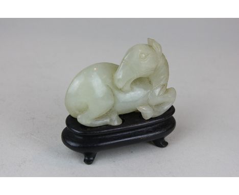 A Chinese mutton fat jade horse on hardwood stand, 6cm wide