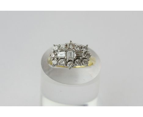 A diamond cluster ring, claw set with three baguette diamonds within a border of twelve brilliant cuts