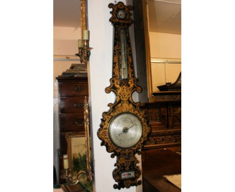 A 19th century papier mache wall barometer and thermometer, with scroll border and allover gilt decoration, 98cm.