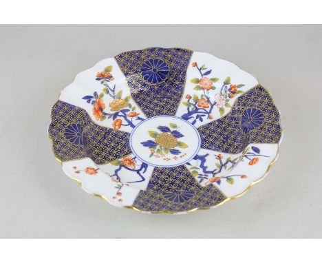 A Royal Worcester porcelain scalloped dish with blue and gilt decoration depicting cherry blossoms and chrysanthemums, in the