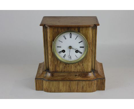 A 19th century French eight day mantel clock by Martin, Paris, with oak case, white enamel dial with Roman  numerals, 18cm