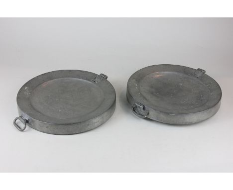 Two 18th century pewter warming plates with two ring handles and lift up flap to well stamped to base, made in London, superf